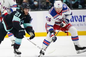 Seattle Kraken center Alex Wennberg (21) and New York Rangers center Ryan Strome (16) battle for the puck during the first period of an NHL hockey game, Sunday, Oct. 31, 2021, in Seattle. (AP Photo/Lindsey Wasson)