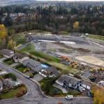 Homes in The Point subdivision border construction at the former Go East Corp. landfill in Everett. (Olivia Vanni / The Herald)