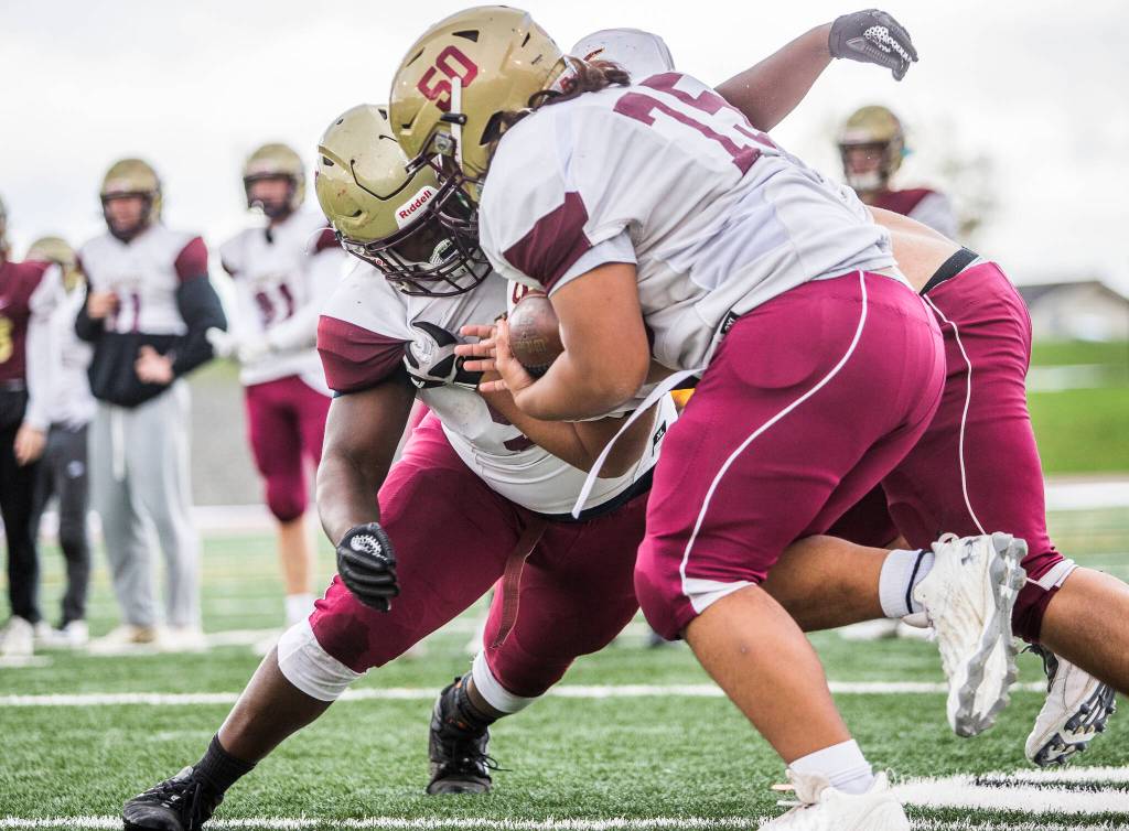 Jakobus Seth (left) runs through blocking drills during football practice at Lakewood High School on Oct. 26 in Arlington. (Olivia Vanni / The Herald)