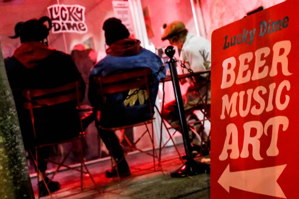 Concert-goers grab some fresh air outside Lucky Dime in Everett on Oct. 30. (Kevin Clark / The Herald)