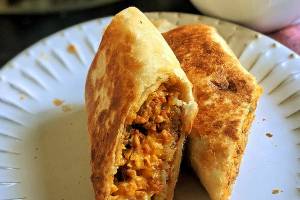 A flour tortilla stuffed with chorizo sausage, scrambled eggs, crispy potatoes and Mexican cheese makes the perfect breakfast-on-the-go. (Gretchen McKay/Pittsburgh Post-Gazette/TNS)