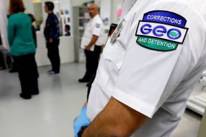 FILE - In this June 21, 2017, file photo, a guard with the GEO Group stands in a detainee processing section of the Northwest Detention Center in Tacoma, Wash., during a media tour of the facility.  The Trump administration is opposing Washington state’s effort to make a privately run, for-profit immigration jail pay detainees minimum wage for the work they do.
Washington Attorney General Bob Ferguson sued The GEO Group in 2017, saying its Northwest Detention Center in Tacoma must pay the state minimum wage to detainees who perform kitchen, janitorial and other tasks. (AP Photo/Ted S. Warren, File)