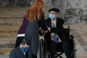 Secretary of State Kim Wyman, left, greets Jack Arends, center, a member of Washington's Electoral College, after members cast their votes in Olympia, Wash., Monday, Dec. 14, 2020. (AP Photo/Ted S. Warren)