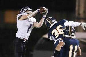 Kamiak's Wesley Garrett (1) grabs a pass and runs in for a touchdown Kamiak beat Mariner 41-14  in a football game at Goddard Stadium on Tuesday, Oct. 19, 2021 in Everett, Washington.  (Andy Bronson / The Herald)
