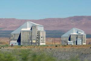 FILE - The decommissioned plutonium-producing DR reactor, left, and D reactor, right, are shown on the Hanford Nuclear Reservation, June 13, 2017, near Richland, Wash. The federal government is moving forward with the cost-saving "cocooning" of eight plutonium production reactors at Hanford that will place them in a state of long-term storage for decades to allow radiation inside to dissipate until they can be dismantled and buried. (AP Photo/Nicholas K. Geranios, File)