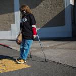 Leigh Spruce navigates from of the ramp cutouts and crosswalks at the Everett Mall on Thursday, March 11, 2021 in Everett, Wa. (Olivia Vanni / The Herald)