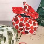 Caption: Green your holiday present wrapping process by choosing reusable fabric and recyclable paper.