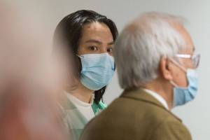 Duy Phuong Nguyen, 28, of Everett, listens to his interpreter (right) during a plea hearing at the Snohomish County Courthouse on Tuesday, Oct. 5, 2021 in Everett, Washington. Nguyen pleaded guilty to first-degree murder for the killing of Thanh Vy Ly, 20, and to two counts of first-degree assault for shooting Ly’s boyfriend and his own wife in 2020. (Andy Bronson / The Herald)
