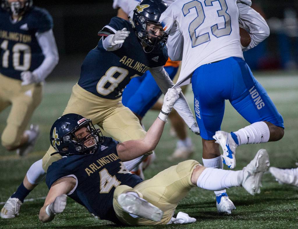 Arlingtons Spencer Fischer grabs onto Auburn Mountainviews Joeray Kilgore jersey during the game against Auburn Mountainview on Friday, Nov. 5, 2021 in Arlington, Wa. (Olivia Vanni / The Herald)