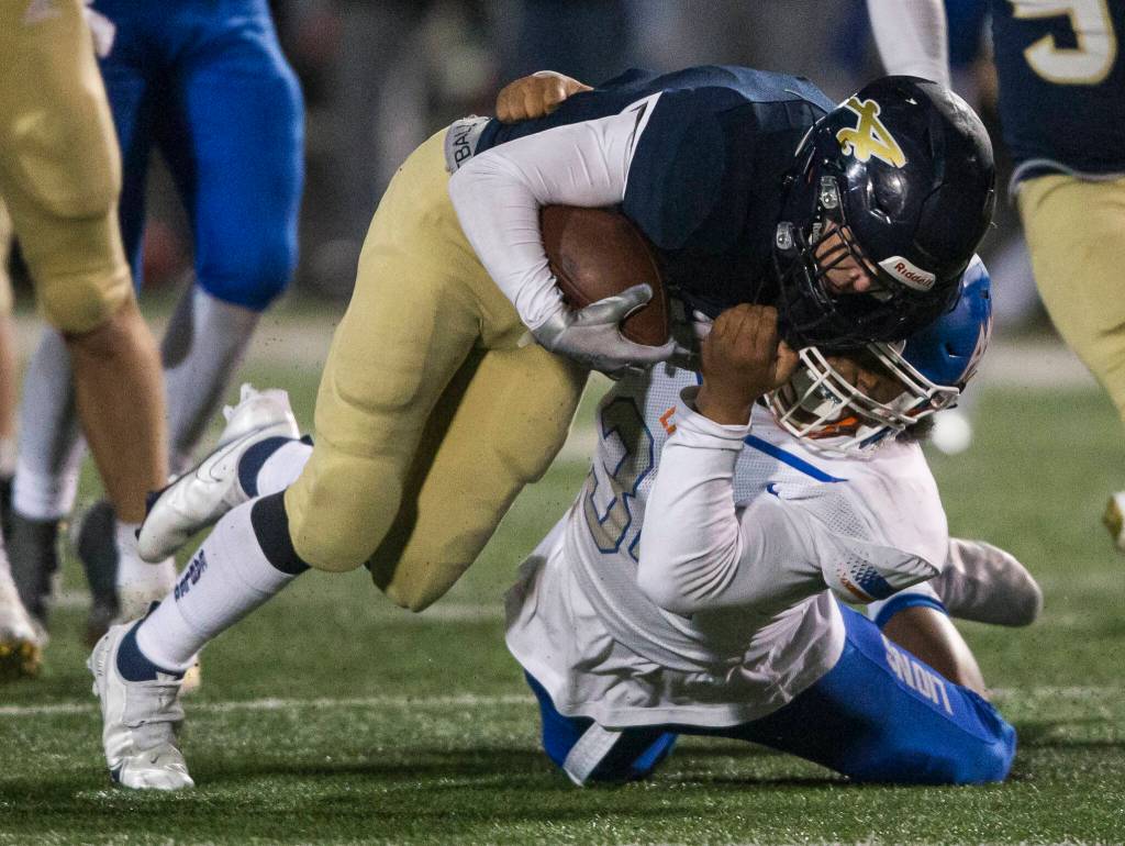 Arlingtons RJ Gese is tackled during the game against Auburn Mountainview on Friday, Nov. 5, 2021 in Arlington, Wa. (Olivia Vanni / The Herald)
