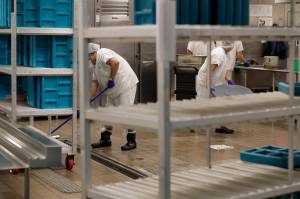 Workers are shown in the kitchen of The GEO Groups immigration detention center in Tacoma during a media tour, Sept. 10, 2019. (AP Photo/Ted S. Warren, File)