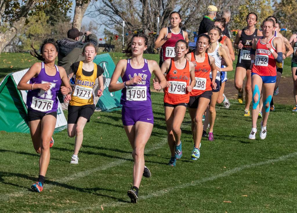 Kamiaks Bella Hasan (1776) and Lake Stevens Ashley Reeck (1790) compete during the WIAA 4A Girls State Cross Country Championships on Saturday at Sun Willows Golf Course in Pasco. (TJ Mullinax/For The Herald)