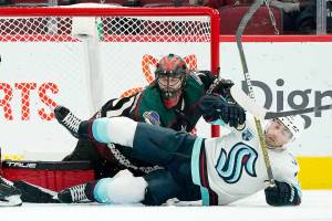 Seattle Kraken right wing Jordan Eberle, right, falls to the ice over Arizona Coyotes goalie Scott Wedgewood, left, during the first period of an NHL hockey game Saturday, Nov. 6, 2021, in Glendale, Ariz. (AP Photo/Ross D. Franklin)