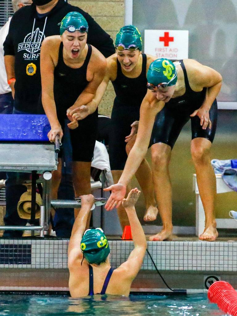Shorecrest celebrates their first place finish in the 200 yard freestyle relay during the 3A District Championships Saturday afternoon the at the Snohomish Aquatic Center on November 6, 2021. (Kevin Clark / The Herald)