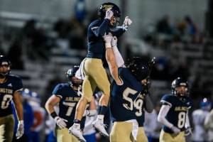 Arlington's Nolan Welch lifts up Levi Younger in celebration of his touchdown during the game against Auburn Mountainview on Friday, Nov. 5, 2021 in Arlington, Wa. (Olivia Vanni / The Herald)