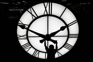 Electric Time technician Dan LaMoore adjusts a clock hand on a 1000-lb., 12-foot diameter clock constructed for a resort in Vietnam, Tuesday, March 9, 2021, in Medfield, Mass. Daylight saving time begins at 2 a.m. local time Sunday, March 14, 2021, when clocks are set ahead one hour. (AP Photo/Elise Amendola)