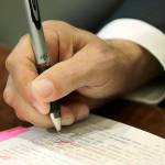 Washington Gov. Jay Inslee uses a red pen to veto sections of the state operating budget in 2019 at the Capitol in Olympia. (AP File/Ted S. Warren)
