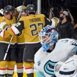 The Golden Knights celebrate right wing Evgenii Dadonovs goal against Kraken goaltender Chris Driedger during the second period of a game Tuesday in Las Vegas. (AP Photo/David Becker)