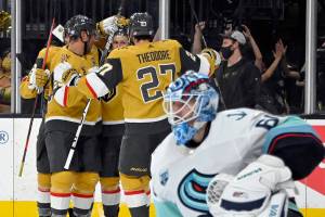 The Vegas Golden Knights celebrate right wing Evgenii Dadonov's goal against Seattle Kraken goaltender Chris Driedger during the second period of an NHL hockey game Tuesday, Nov. 9, 2021, in Las Vegas. (AP Photo/David Becker)