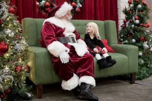 Dylan Blaney, 3, talks with Santa about what she wants for Christmas at the Santa Magic experience at Alderwood Mall on Friday, Nov. 19, 2021 in Lynnwood, Wa. (Olivia Vanni / The Herald)