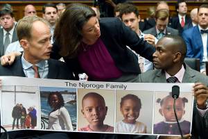 FILE - In this Wednesday, July 17, 2019, file photo, Rep. Angie Craig, D-Minn., center, talks with Paul Njoroge, right, who lost his wife and three young children, as Michael Stumo, left, who lost his daughter, looks on before the start of a House Transportation subcommittee hearing on aviation safety, on Capitol Hill in Washington. The year since the crash of an Ethiopian Airlines Boeing 737 Max has been a journey through grief, anger and determination for the families of those who died, as well as having far-reaching consequences for the aeronautics industry as it brought about the grounding of all Boeing 737 Max 8 and 9 jets, which remain out of service. (AP Photo/Susan Walsh, File)