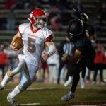 Stanwood running back Ryder Bumgarner turns the corner after evading a tackle attempt by Lincolns Drake Cranberry during the first quarter of a 3A winner-to-state playoff game on Nov. 5 at the Lincoln Bowl in Tacoma. (Pete Caster / The News Tribune)