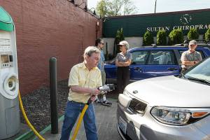 Ian Terry / The Herald

Brian Henderson, of Renton, plugs in his Kia Soul EV electric vehicle at a charging station in Sultan on Wednesday, June 7. Henderson and a group of fellow electric car drivers made the trip from Everett's City Hall to Spokane's City Hall late last week in an effort to raise awareness about convenient charging locations along U.S. Highway 2.

Photo taken on 06072017