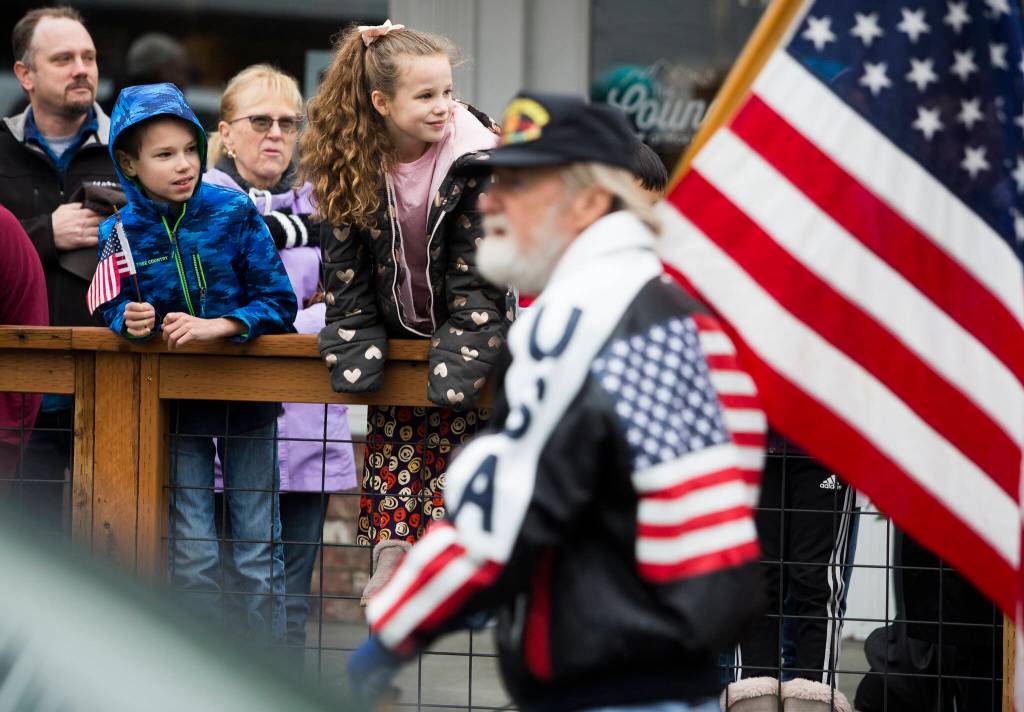 Children watch the Veterans Day Parade as it makes its way down Olympic Avenue on Thursday, Nov. 11, 2021 in Arlington, Wa. (Olivia Vanni / The Herald)