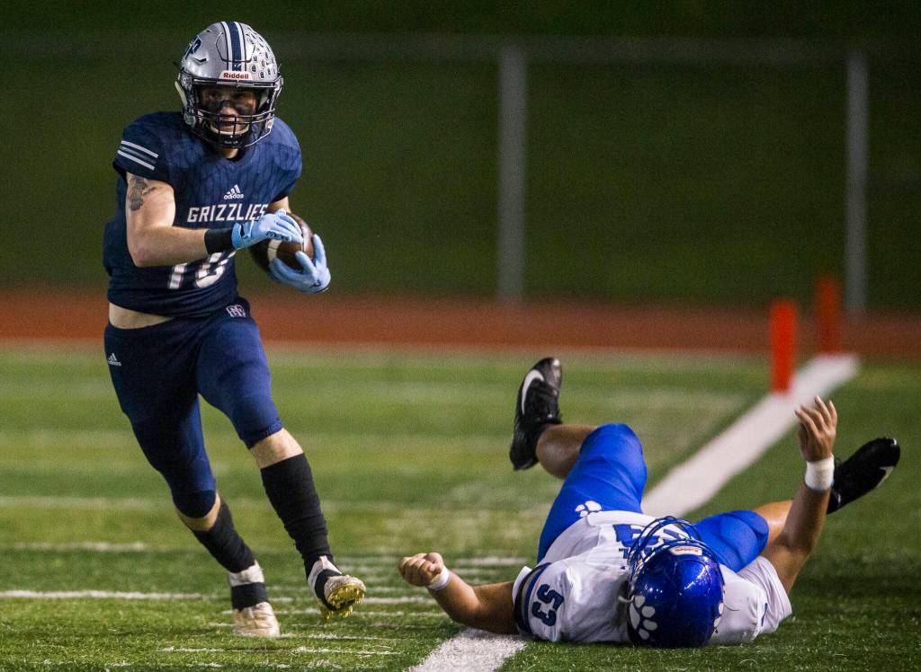 Glacier Peaks Ryan King shakes a tackle by Bothells Saivon Soeum and runs down the sideline during the game on Friday, Nov. 12, 2021 in Snohomish, Wa. (Olivia Vanni / The Herald)