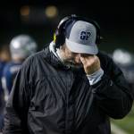 A Glacier Peak coach rubs his head after losing to Bothell on Friday, Nov. 12, 2021 in Snohomish, Wa. (Olivia Vanni / The Herald)