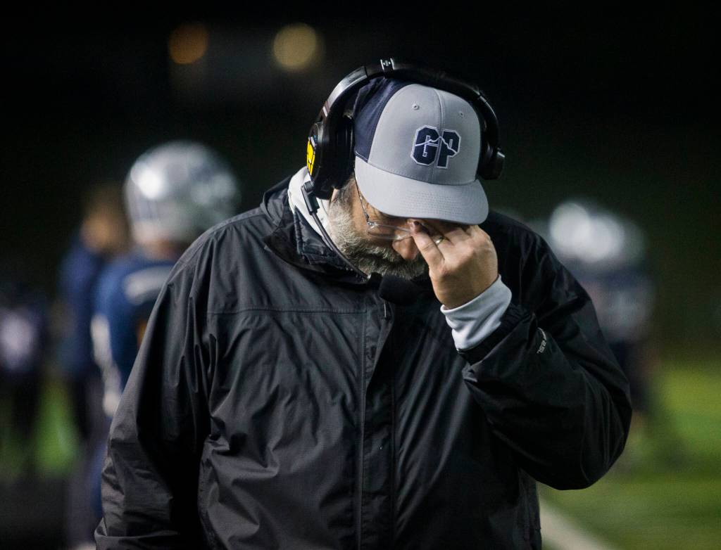 A Glacier Peak coach rubs his head after losing to Bothell on Friday, Nov. 12, 2021 in Snohomish, Wa. (Olivia Vanni / The Herald)