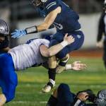 Glacier Peaks Ryan King jumps over a tackle while he runs the ball during the game against Bothell on Friday, Nov. 12, 2021 in Snohomish, Wa. (Olivia Vanni / The Herald)