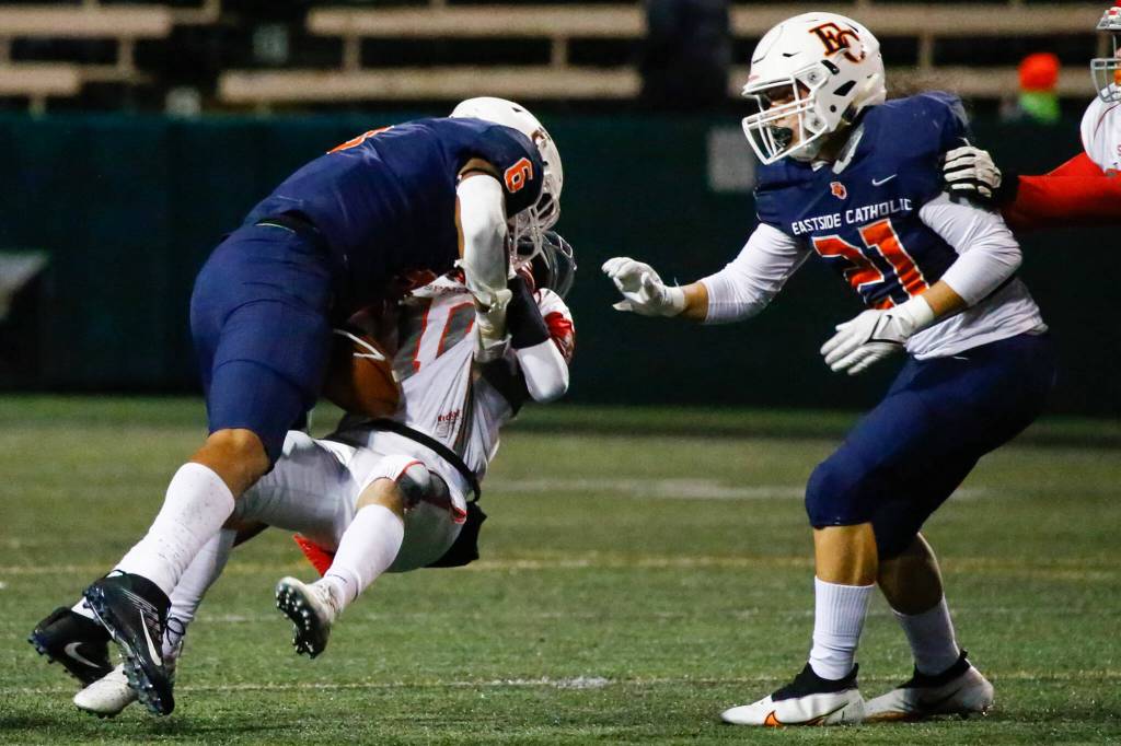Eastside Catholics Samuel Burroughs sacks Stanwoods Michael Mascotti forcing a fumble with Eastside Catholics Nehemiah Faleulu Friday night during the 3A playoff game at Memorial Stadium in Seattle on November 12, 2021. Eastside Catholic led 28-6 at the half. (Kevin Clark / The Herald)