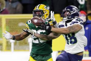 Green Bay Packers' Darnell Savage breaks up a pass intended for Seattle Seahawks' Freddie Swain during the second half of an NFL football game Sunday, Nov. 14, 2021, in Green Bay, Wis. (AP Photo/Aaron Gash)