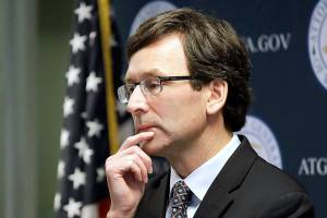 FILE - Washington state Attorney General Bob Ferguson looks on during a news conference in Seattle on Dec. 17, 2019. Ferguson rejected a half-billion-dollar settlement offer, and now he's taking the state's case against the nation's three biggest drug distributors to trial Monday, Nov. 15, 2021. He says they must be held accountable for their role in the opioid crisis. (AP Photo/Elaine Thompson, File)