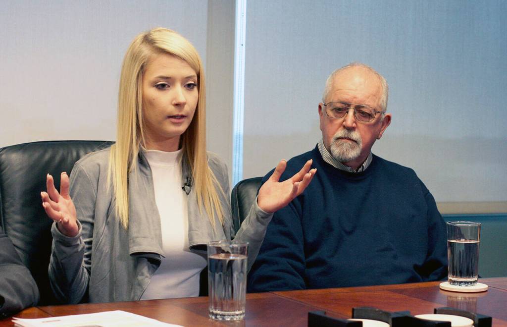 Britt Jakobsen (left) speaks to reporters in Seattle on Nov. 21, 2018. She was in the passenger seat when her boyfriend, Nickolas Peters, was shot by a Snohomish County sheriffs deputy. At right is her father, Ken Jakobsen. (Zachariah Bryan / Herald file)