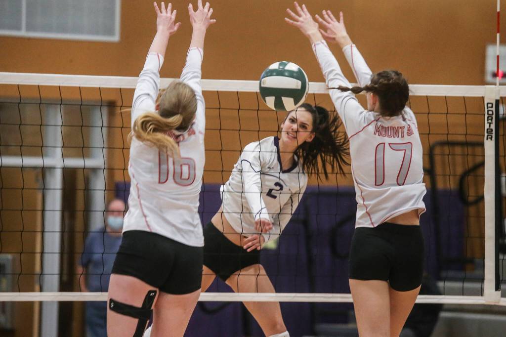 Lake Stevens Isabella Christensen sends the ball past two defenders as Lake Stevens beat Mount Si in five sets in a Class 4A Wes-King Bi-District Tournament semifinal volleyball match on Nov. 9 in Lake Stevens. (Andy Bronson / The Herald)