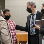 Algeria Canales, a sister of Alisha Canales-McGuire, becomes emotional while speaking with deputy prosecutor Jarett Goodkin, after the jury found Kevin Lewis guilty of first-degree murder Thursday, Nov. 18, 2021, in Everett. (Olivia Vanni / The Herald)