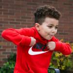 Robert, 5, imitates a turkey as he answers questions about Thanksgiving outside Mount Pilchuck Elementary on Monday in Lake Stevens. (Andy Bronson / The Herald)