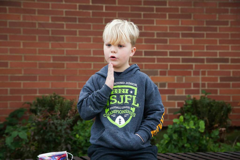 Nixon, 6, describes a turkeys wattle as he answers questions about Thanksgiving outside Mount Pilchuck Elementary on Monday in Lake Stevens. (Andy Bronson / The Herald)
