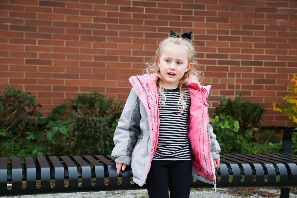 Gemma, 5, answers questions about Thanksgiving outside Mount Pilchuck Elementary on Monday in Lake Stevens. (Andy Bronson / The Herald)