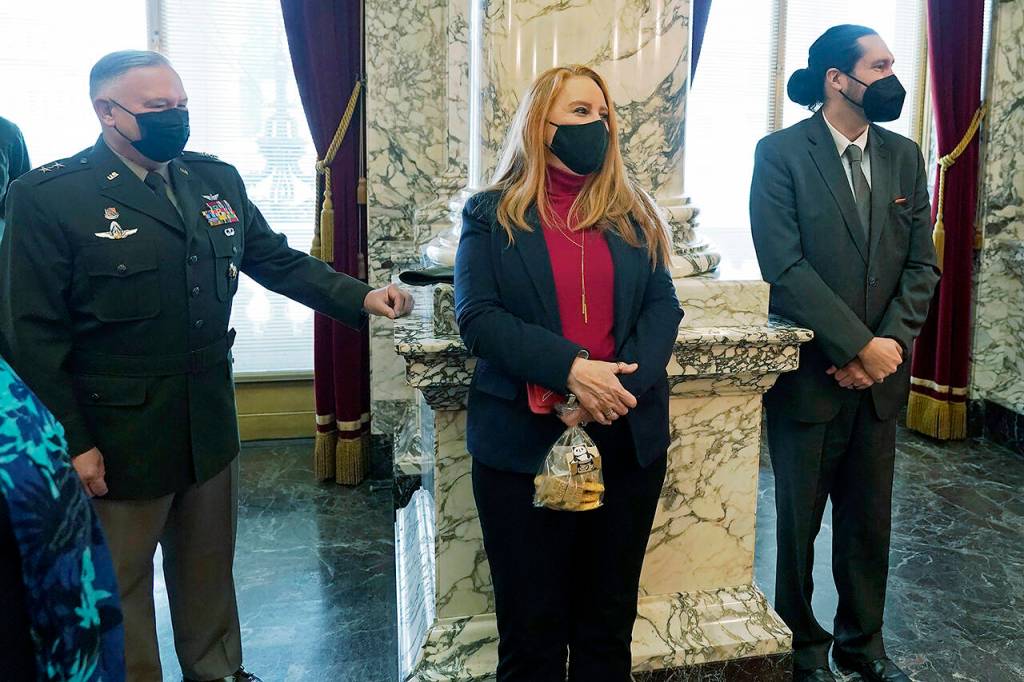 Former Washington Secretary of State Kim Wyman (center) listens as Steve Hobbs speaks after he was sworn in as her replacement Monday at the Capitol in Olympia. (AP Photo/Ted S. Warren)