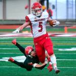 Marysville Pilchuck running back Dylan Carson slips through the tackle of Yelm defensive back Kyler Ronquillo during a 3A football state quarterfinal game on Saturday, Nov. 20, 2021, at Yelm High School. Marysville Pilchuck won the game 39-21. (Tony Overman / The Olympian)