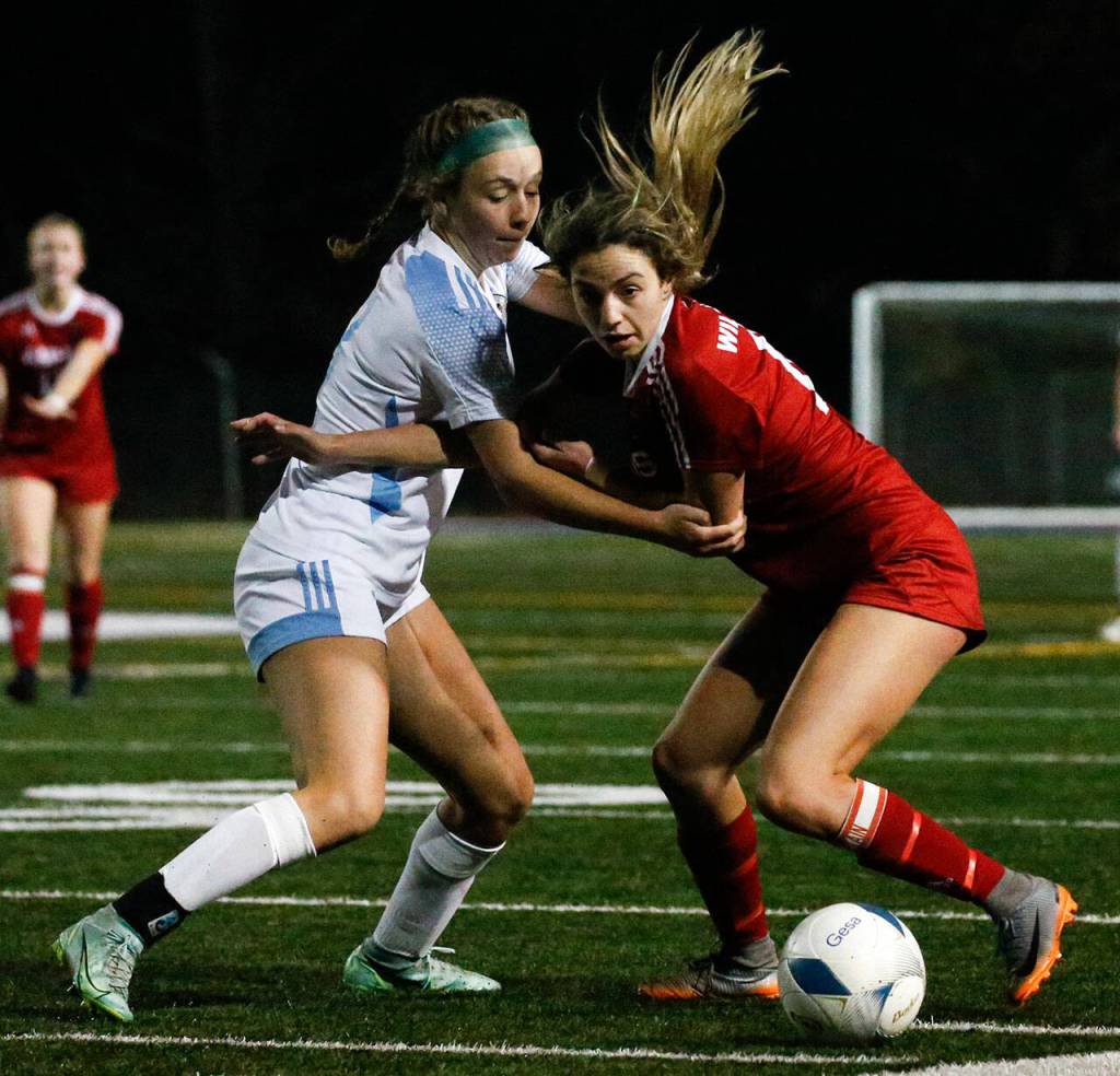 Hockinsons Grace Abbott, left, and Archbishop Murphys Taylor Campbell vie for the ball Saturday evening during the 2A state championship at Shoreline Stadium on November 20, 2021. The Wildcats won 2-0. (Kevin Clark / The Herald)