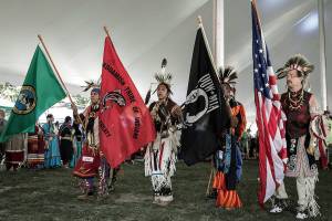 Stillaguamish tribal members hold flags during a powwow. (Contributed)