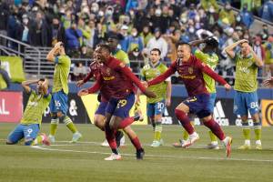 Real Salt Lake players celebrate the team's win over the Seattle Sounders in a penalty-kick shootout in an MLS first-round playoff soccer match Tuesday, Nov. 23, 2021, in Seattle. (AP Photo/Ted S. Warren)