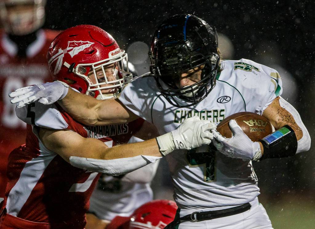 Marysville Pilchucks Dylan Carson reaches out to tackle Marysville Getchells Riley Riba during the Berry Bowl on Sept. 17 in Marysville. (Olivia Vanni / The Herald)