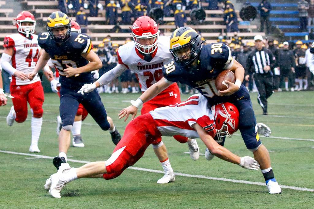 Marysville-Pilchucks Lucian Curtis tackles Bellevues William Wang just shy of the end zone Saturday afternoon at Memorial Stadium in Seattle on November 27, 2021. The Tomahawks fell to the Wolverines 27-3 ending their playoff run. (Kevin Clark / The Herald)