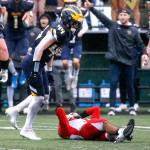 Marysville-Pilchucks Gaylan Gray is tackled by Bellevues George Kruger Saturday afternoon at Memorial Stadium in Seattle on November 27, 2021. The Tomahawks fell to the Wolverines 27-3 ending their playoff run. (Kevin Clark / The Herald)