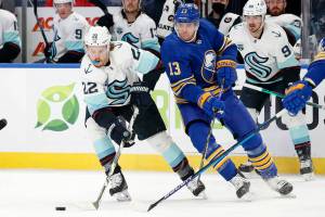 Seattle Kraken center Mason Appleton (22) carries the puck past Buffalo Sabres defenseman Mark Pysyk (13) during the second period of an NHL hockey game, Monday, Nov. 29, 2021, in Buffalo, N.Y. (AP Photo/Jeffrey T. Barnes)